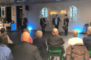 Prinicipal Flack opens the party in front of members from the marching band.